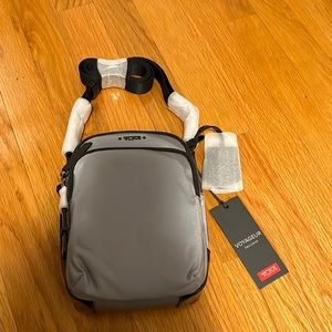 New with tags grey TUMI Voyageur crossbody bag. NWT